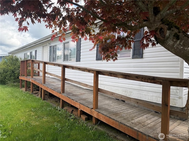 wooden terrace with a yard