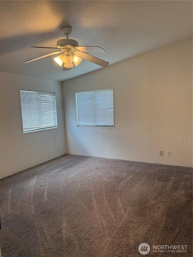 unfurnished room with a textured ceiling, carpet, and ceiling fan
