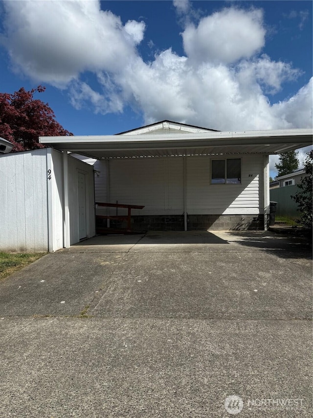 exterior space with an attached carport and concrete driveway