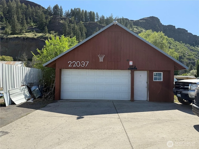 detached garage featuring a mountain view and a wooded view
