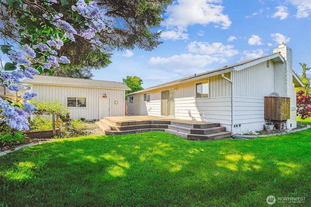 1015 14th St NW, Puyallup, WA 98371 - rear view of property with a wooden deck, a yard, and a chimney