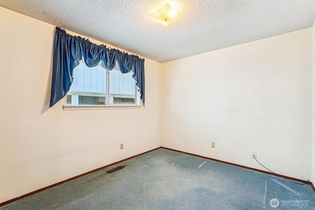 1015 14th St NW, Puyallup, WA 98371 - carpeted spare room with baseboards, a textured ceiling, and visible vents