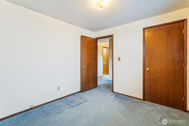 1015 14th St NW, Puyallup, WA 98371 - unfurnished bedroom featuring a textured ceiling, light carpet, and baseboards