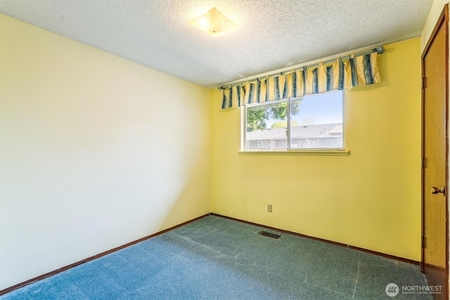 1015 14th St NW, Puyallup, WA 98371 - unfurnished bedroom featuring a textured ceiling, visible vents, baseboards, and carpet