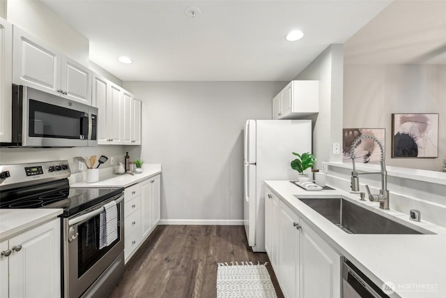 kitchen featuring light countertops, a sink, white cabinets, and stainless steel appliances