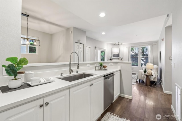 kitchen featuring a sink, dishwasher, white cabinetry, recessed lighting, and dark wood-type flooring