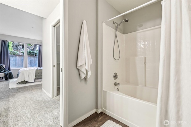 full bathroom featuring baseboards, connected bathroom, and shower / bath combo with shower curtain