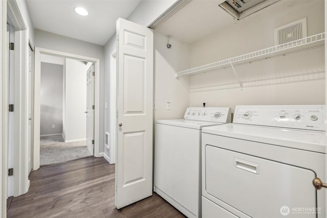 laundry area with separate washer and dryer, laundry area, dark wood finished floors, and baseboards
