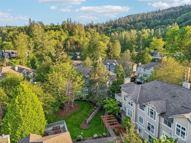 birds eye view of property featuring a forest view and a residential view