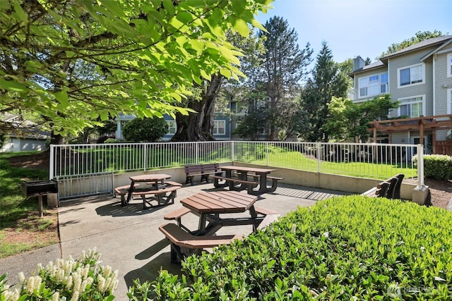 view of home's community featuring a patio and fence