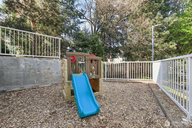 view of playground with a fenced backyard