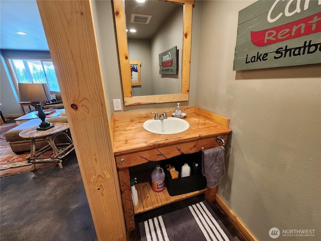 bathroom with concrete flooring, visible vents, and vanity