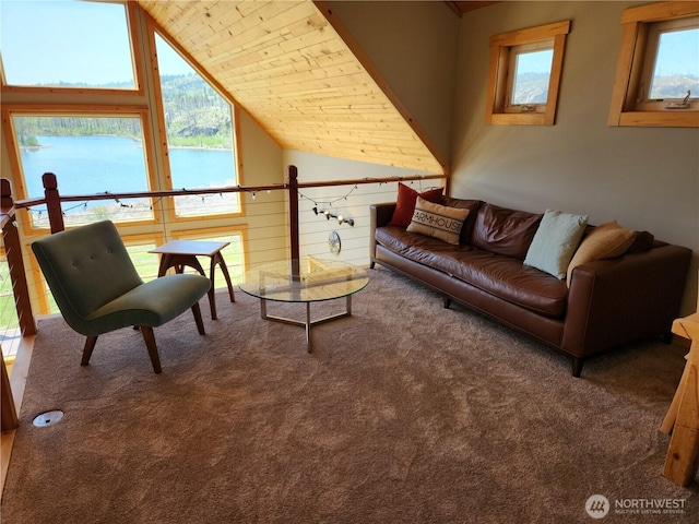 living area featuring carpet, a water view, and vaulted ceiling