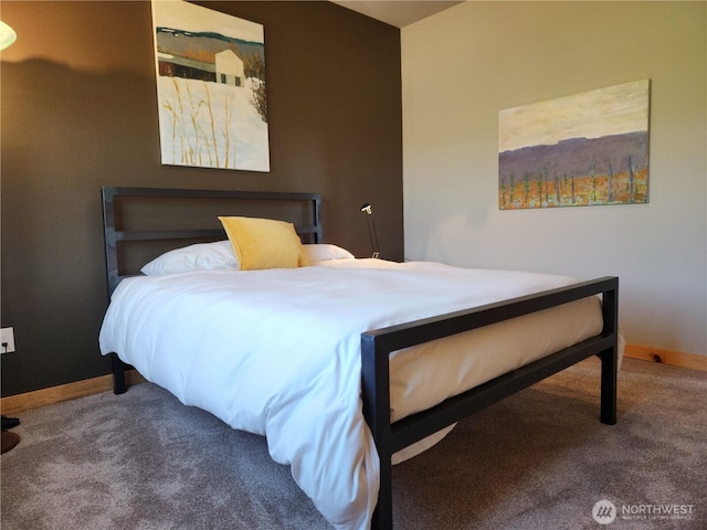 bedroom featuring baseboards and carpet