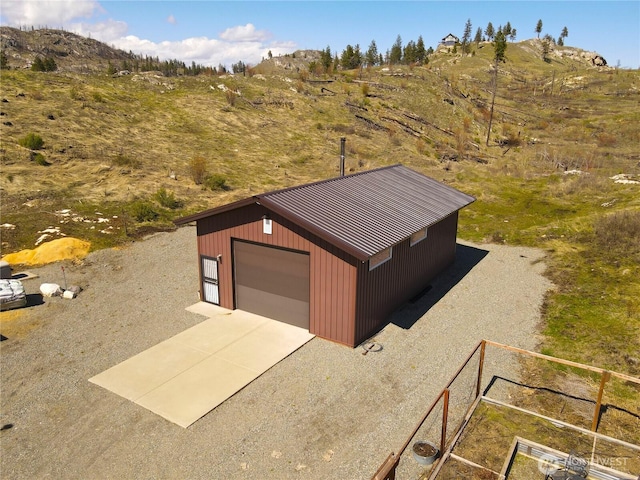 detached garage featuring concrete driveway