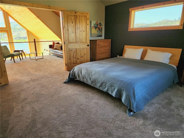 bedroom with carpet, vaulted ceiling, and multiple windows