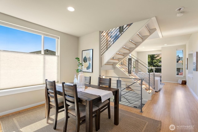 dining area featuring wood-type flooring, recessed lighting, and baseboards