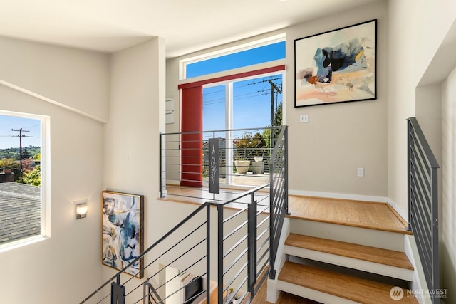 stairs featuring baseboards and wood finished floors