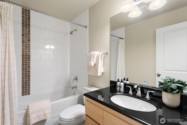 bathroom featuring vanity, shower / bath combination with curtain, and toilet