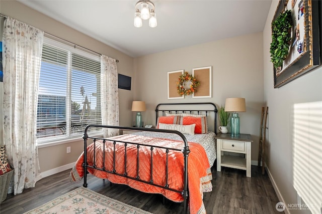 bedroom featuring baseboards and wood finished floors