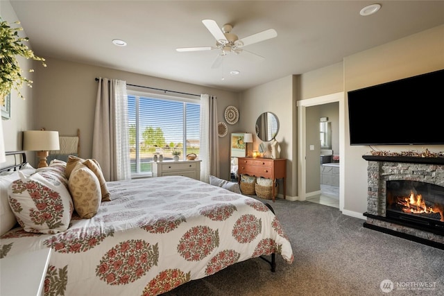 carpeted bedroom with a fireplace, ensuite bathroom, baseboards, ceiling fan, and recessed lighting
