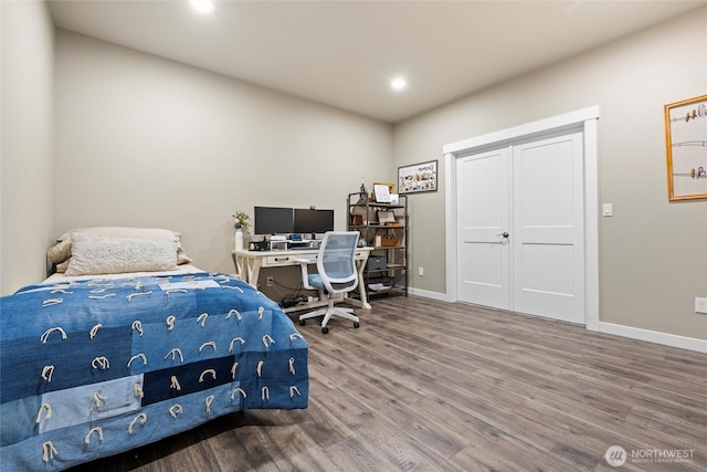 bedroom with recessed lighting, baseboards, and wood finished floors