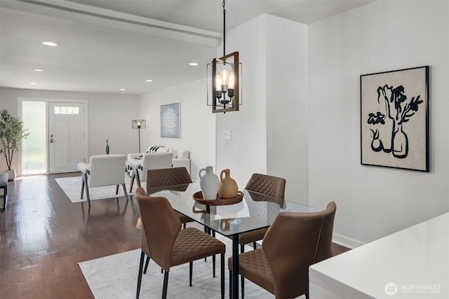 dining space with dark wood-type flooring, recessed lighting, a chandelier, and baseboards