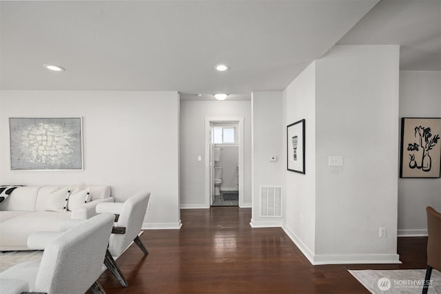 living room featuring wood finished floors, baseboards, and recessed lighting