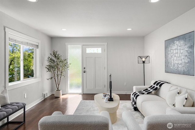 living room featuring plenty of natural light, wood finished floors, recessed lighting, and baseboards