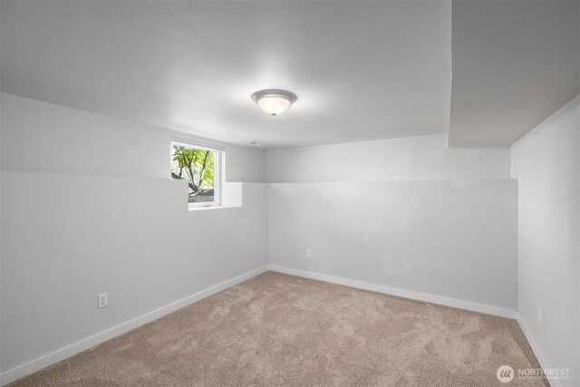 empty room with carpet and baseboards