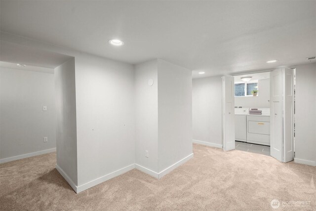 basement with separate washer and dryer, light colored carpet, recessed lighting, and baseboards