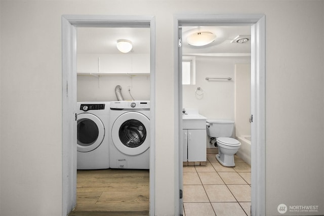 6638 Corson Ave S, Seattle, WA 98108 - washroom with light tile patterned floors, laundry area, and washer and clothes dryer