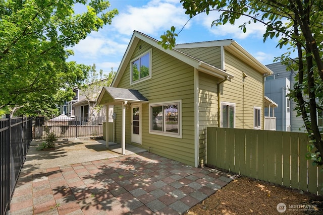 6638 Corson Ave S, Seattle, WA 98108 - rear view of house with a fenced backyard and a patio area