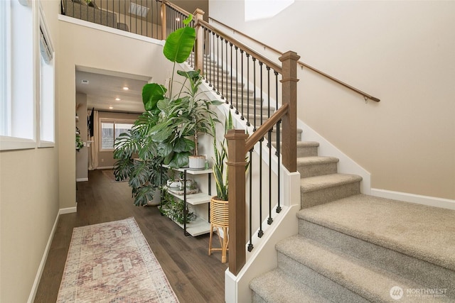 20438 SE 256th St, Covington, WA 98042 - staircase with baseboards, wood finished floors, and a towering ceiling