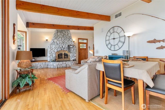 3003 Haxton Way, Bellingham, WA 98226 - living area with light wood-style flooring, beamed ceiling, a stone fireplace, and wood ceiling