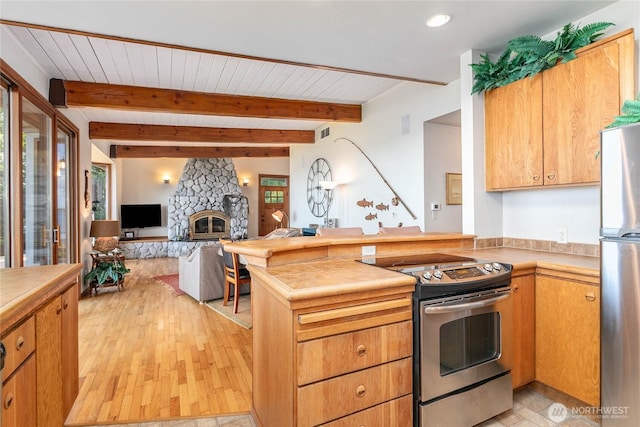 3003 Haxton Way, Bellingham, WA 98226 - kitchen featuring stainless steel appliances, a peninsula, open floor plan, plenty of natural light, and beam ceiling