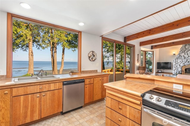 3003 Haxton Way, Bellingham, WA 98226 - kitchen featuring appliances with stainless steel finishes, a sink, open floor plan, beamed ceiling, and a water view