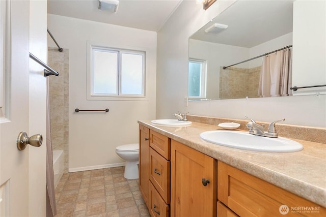 3003 Haxton Way, Bellingham, WA 98226 - bathroom with toilet, double vanity, stone finish floors, and shower / tub combo