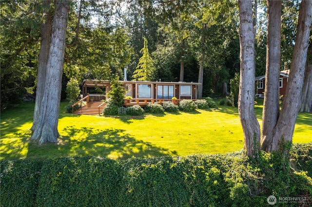 3003 Haxton Way, Bellingham, WA 98226 - view of front of house with a front yard, a wooden deck, and a wooded view