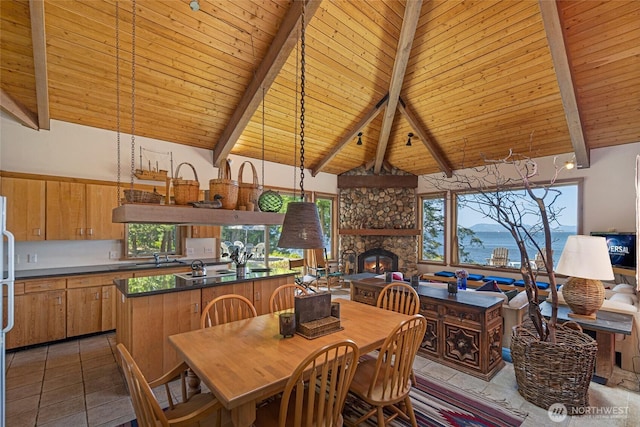 30 Smugglers Rowe, Henry Island, WA 98250 - dining area with wooden ceiling, beamed ceiling, healthy amount of natural light, a stone fireplace, and high vaulted ceiling