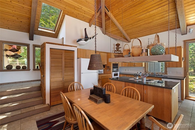 30 Smugglers Rowe, Henry Island, WA 98250 - dining area featuring wooden ceiling, beamed ceiling, a skylight, high vaulted ceiling, and light tile patterned floors