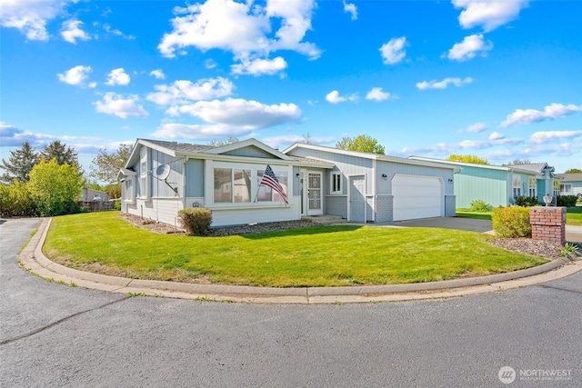 single story home featuring aphalt driveway, a front lawn, and a garage