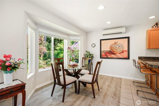 dining space with a wall mounted AC, plenty of natural light, recessed lighting, and light wood finished floors
