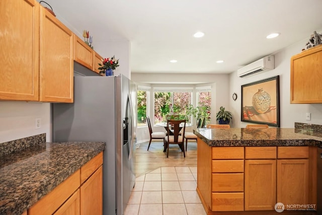 kitchen with a wall mounted air conditioner, stainless steel refrigerator with ice dispenser, a peninsula, recessed lighting, and tile counters