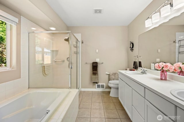 full bath with a stall shower, a bath, tile patterned floors, toilet, and double vanity