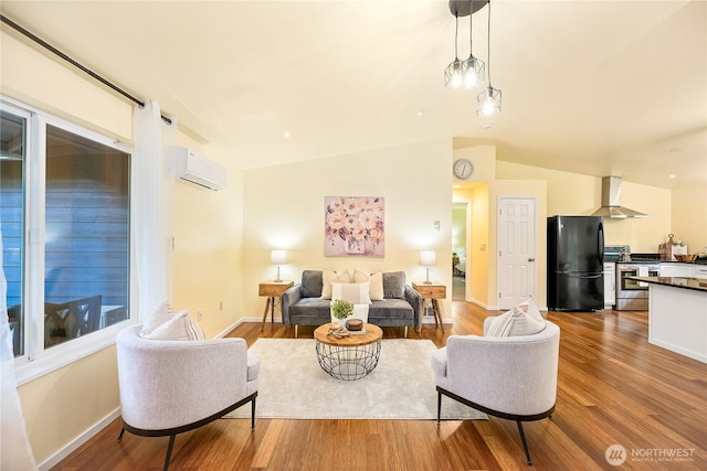 18514 71st St NW, Vaughn, WA 98394 - living room with an AC wall unit, wood finished floors, vaulted ceiling, and baseboards