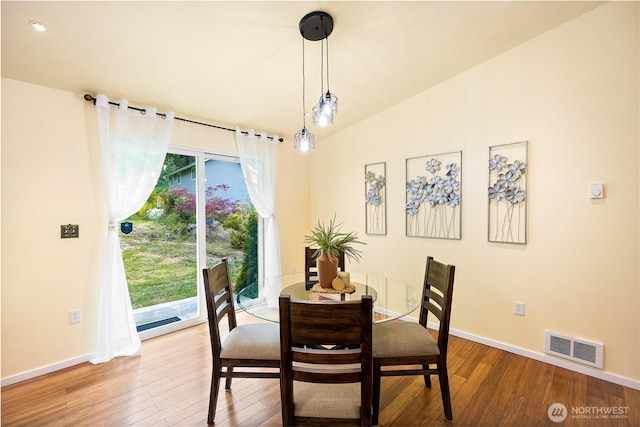 18514 71st St NW, Vaughn, WA 98394 - dining space with baseboards, healthy amount of natural light, wood finished floors, recessed lighting, and lofted ceiling