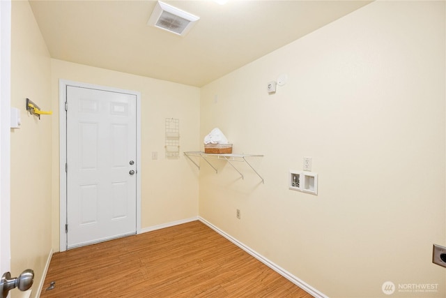 18514 71st St NW, Vaughn, WA 98394 - clothes washing area featuring light wood-type flooring, hookup for a washing machine, baseboards, and hookup for an electric dryer