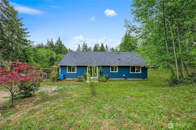 18514 71st St NW, Vaughn, WA 98394 - rear view of house featuring a lawn and roof with shingles