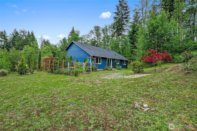 18514 71st St NW, Vaughn, WA 98394 - view of front of house featuring a front yard and a vegetable garden